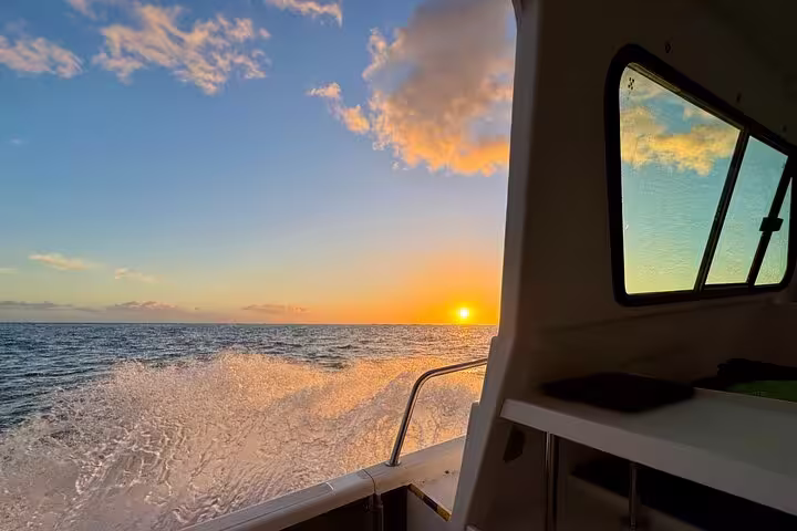 Stunning ocean sunset view from a private cruise deck, capturing the perfect end to a day at sea.