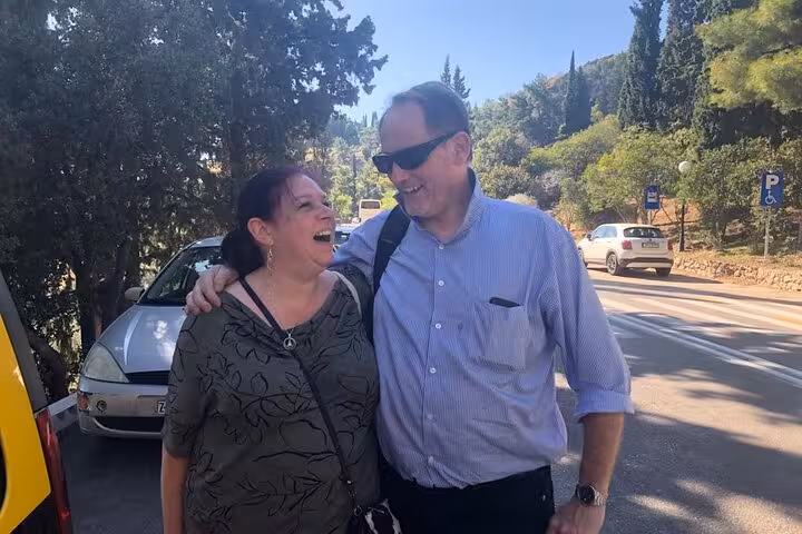 Couple enjoying a private Munich car tour with Dachau Memorial visit, scenic Bavarian countryside stop
