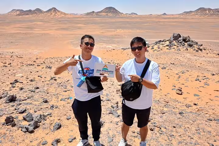 Travelers posing in Bahariya Oasis desert on a private day tour to Egypt’s White Desert from Cairo