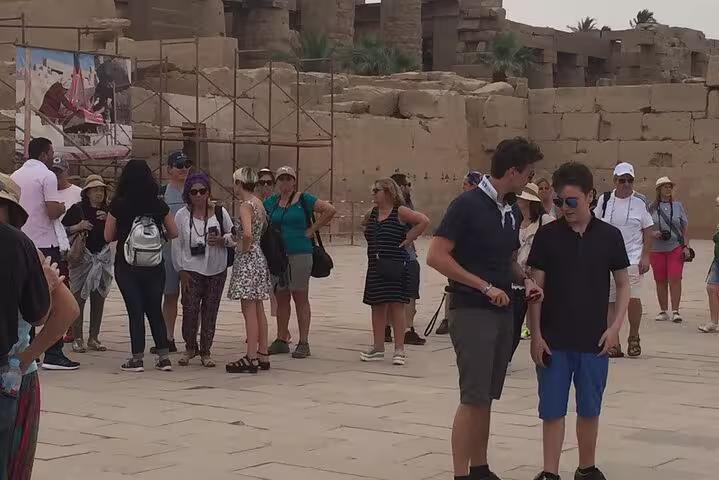 Tour group exploring Karnak Temple courtyard on a private day trip to Luxor from Hurghada with guide
