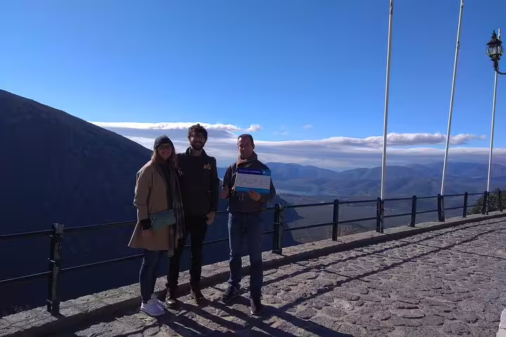 Tourists enjoying breathtaking views of the mountainous landscape during a private day trip from Athens to Delphi.