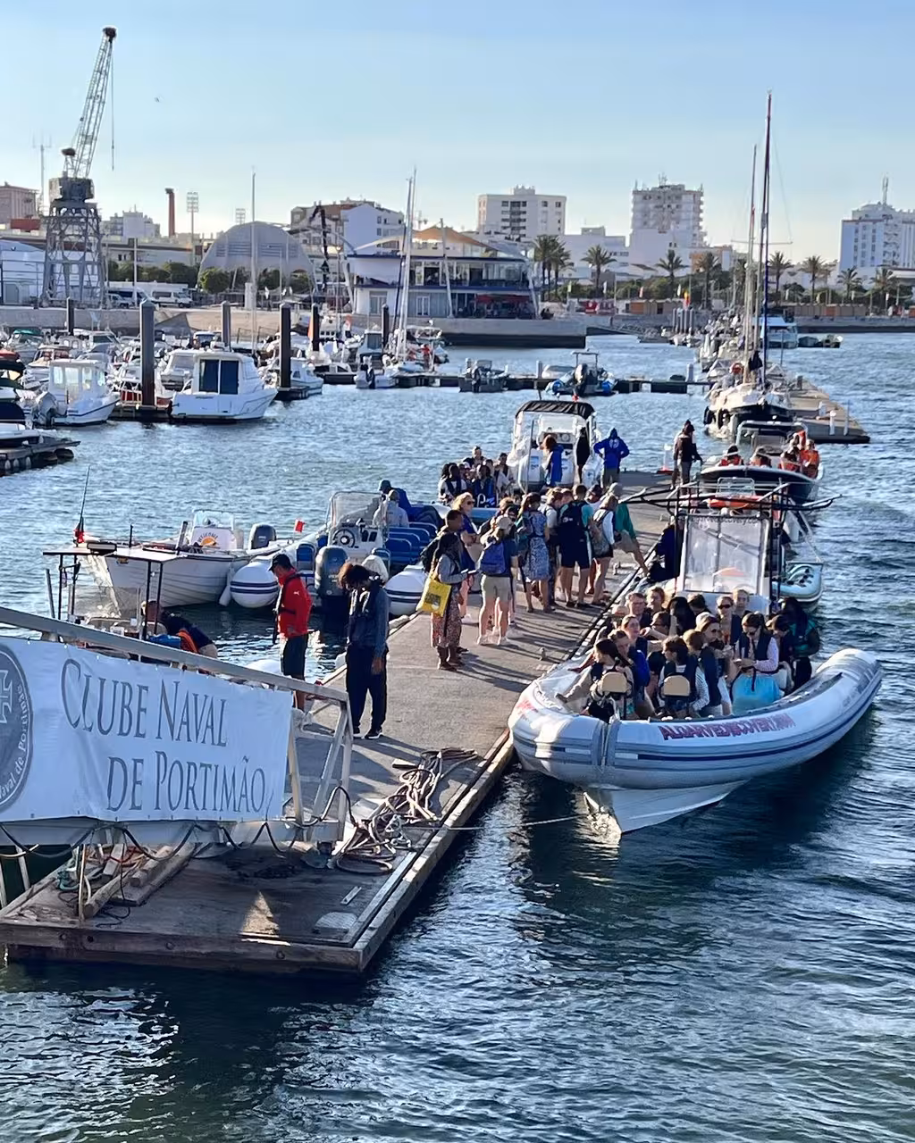 Travelers board a RIB speedboat at Clube Naval de Portimão marina for a private dolphin and marine wildlife expedition in Algarve