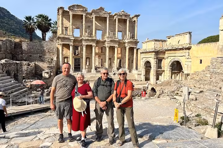 Travelers on skip-the-line private Ephesus tour posing by the Library of Celsus with guide in Turkey