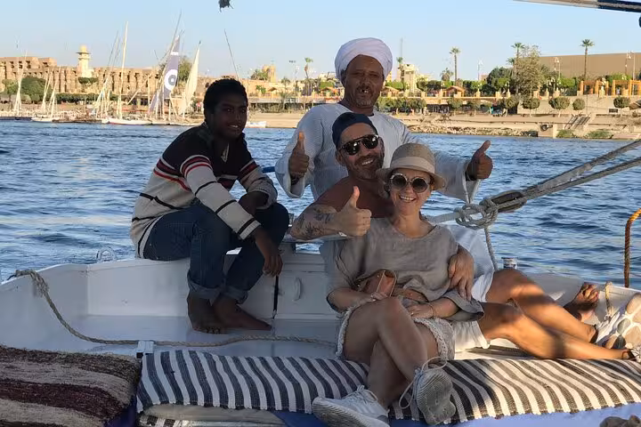 Tourists relaxing on a private felucca in Luxor on the Nile, Banana Island cruise with private transfer
