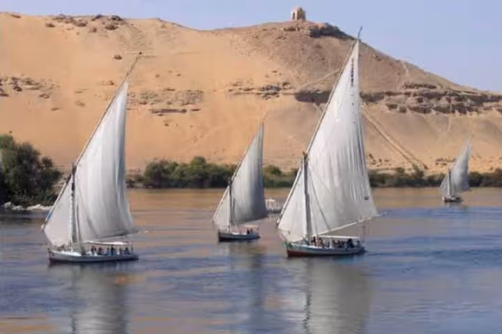 Traditional felucca sailboats cruising the Nile River, ideal for a private felucca ride tour in Cairo Egypt