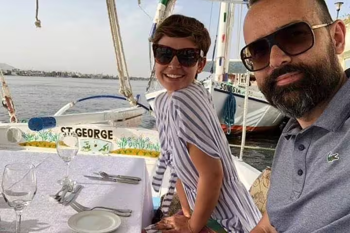 Couple enjoying a private felucca ride on the Nile in Cairo with onboard dining and river views
