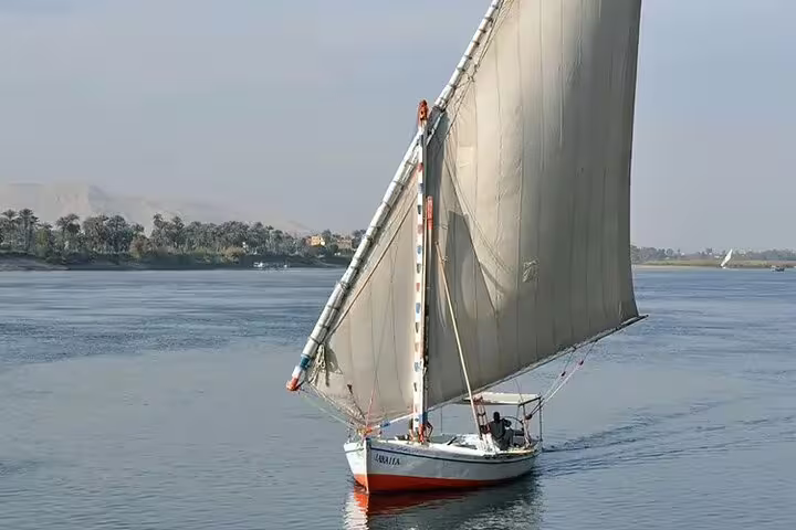 Traditional felucca sailboat gliding on the Nile River in Cairo, ideal for a private felucca ride tour