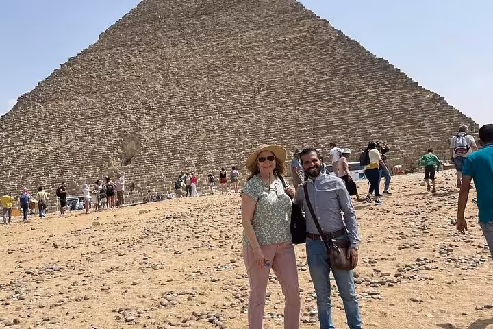 Travelers with local guide at the Great Pyramid of Giza on a private guided tour in Cairo, Egypt