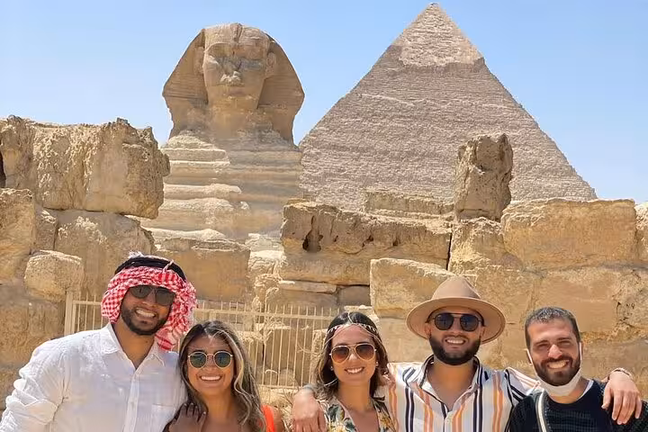 Tour group photo by the Great Sphinx and Giza Pyramid on a private Cairo tour with desert panoramic views
