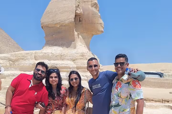 Group posing in front of the Great Sphinx during a private Giza tour featuring pyramids, Memphis, and Saqqara.