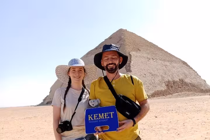 Tourists posing at the Giza Pyramid with Kemet sign, private Giza tour featuring Sphinx, Grand Museum and bazaar