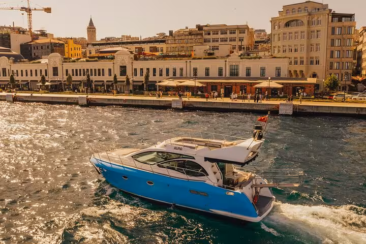 Luxury private yacht cruising the Istanbul Bosphorus Strait with scenic waterfront views on a sunset tour