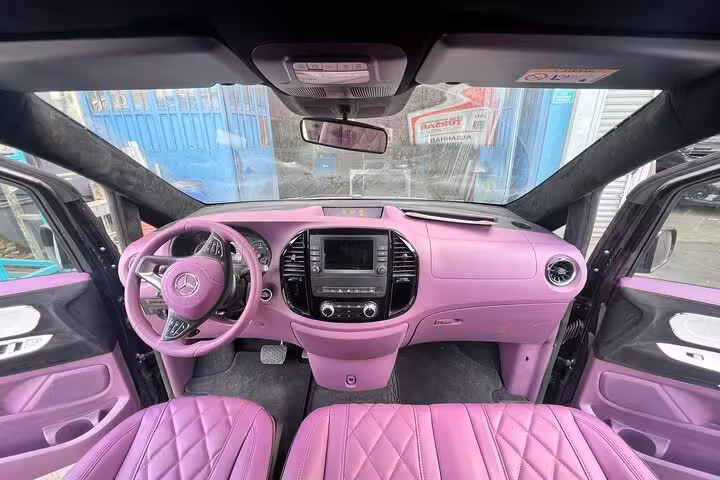 Premium private car rental with driver, showcasing luxury purple interior and spacious seating comfort