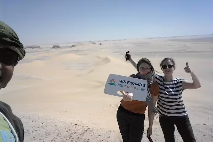 Travelers posing in the White Desert on a private 2-day Jeep safari to Bahariya Oasis with desert guide