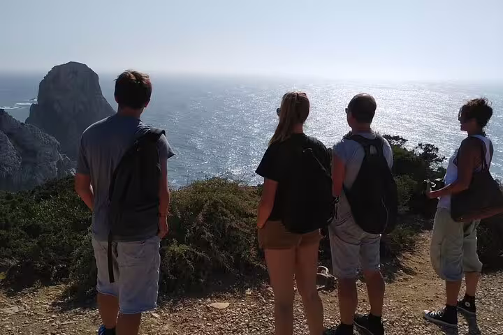 Tourists admire the stunning ocean view from a cliff in Cascais, Portugal during a private jeep tour adventure.