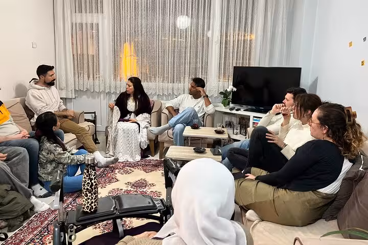 Small group in a cozy Istanbul living room during a private Kurdish Dengbeji music storytelling session