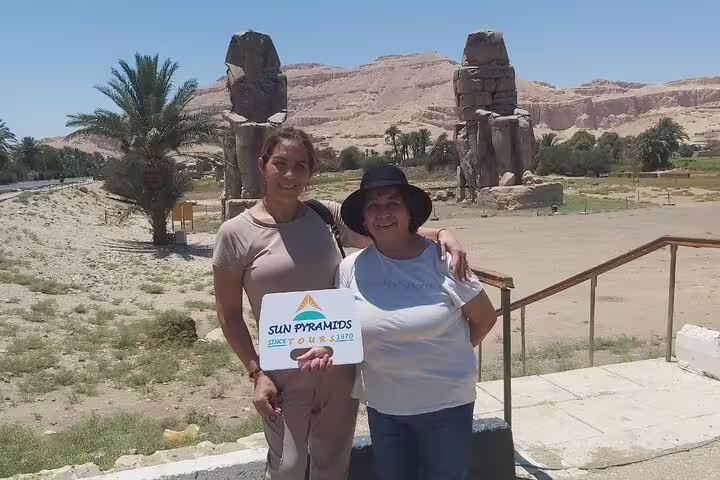 Travelers at Colossi of Memnon on a private Luxor day tour from Hurghada by car, West Bank sightseeing