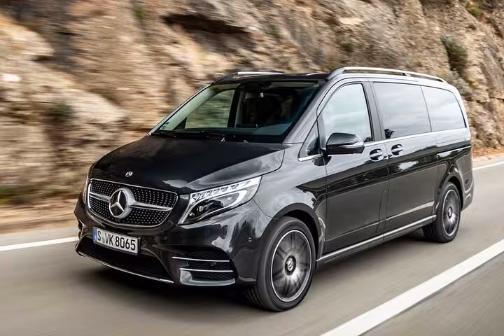 Sleek Mercedes van driving smoothly on road, part of private transfer service to Positano from Sorrento.