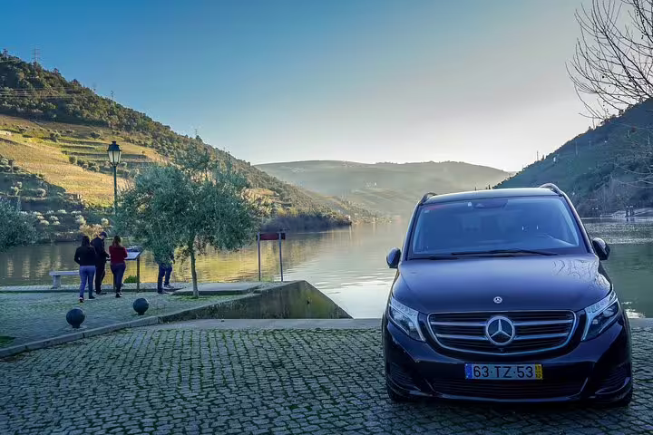 Private Mercedes van by Douro River at sunset, ideal for 2-day Lisbon to Porto & Douro Valley tour transfer