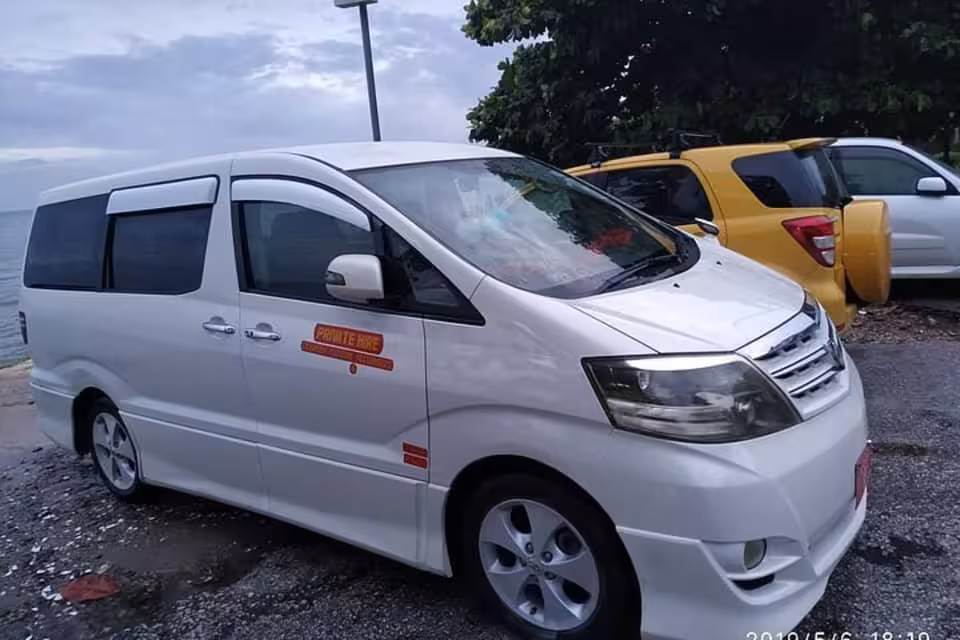 Comfortable private minivan parked by the coast for hassle-free transfer from Pongwe hotels to Zanzibar Airport ZNZ.