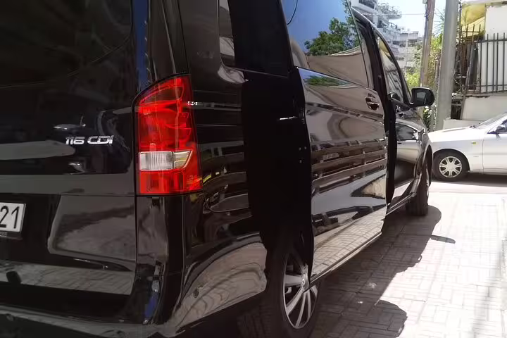 Black minivan with sliding door open for private transfer from Thessaloniki to Athens, hotel pickup Greece