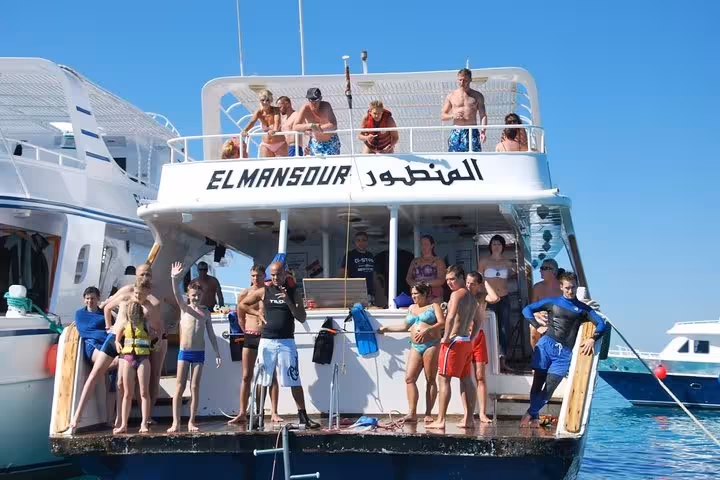 Group boarding a Red Sea cruise boat in Hurghada marina for private trip to Makadi Bay, Soma Bay and Safaga