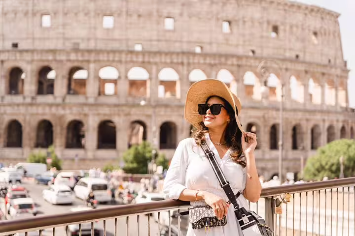 Solo traveler posing by the Colosseum with a private Rome travel photographer for a 3-hour photo session