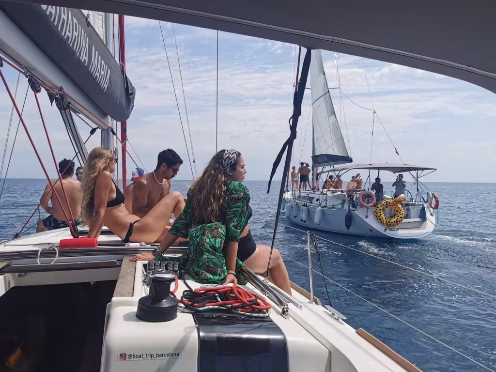 People enjoying a sunny day on a luxurious sailboat during a private 3-hour sailing experience in Barcelona's scenic waters.