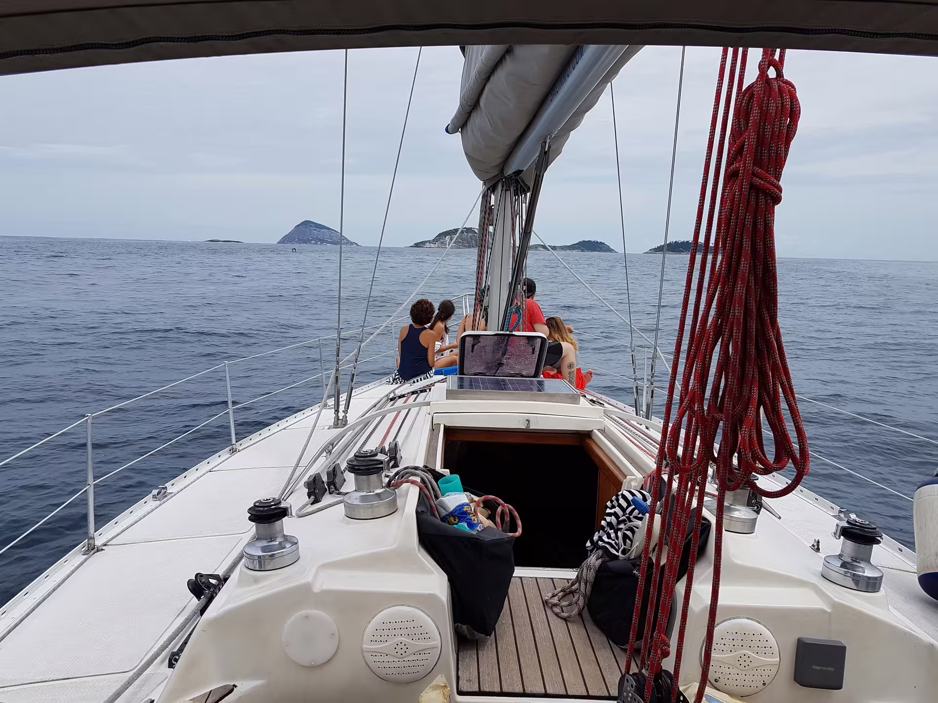 Group enjoying a scenic private sailing tour with distant islands, perfect for relaxation and ocean exploration.