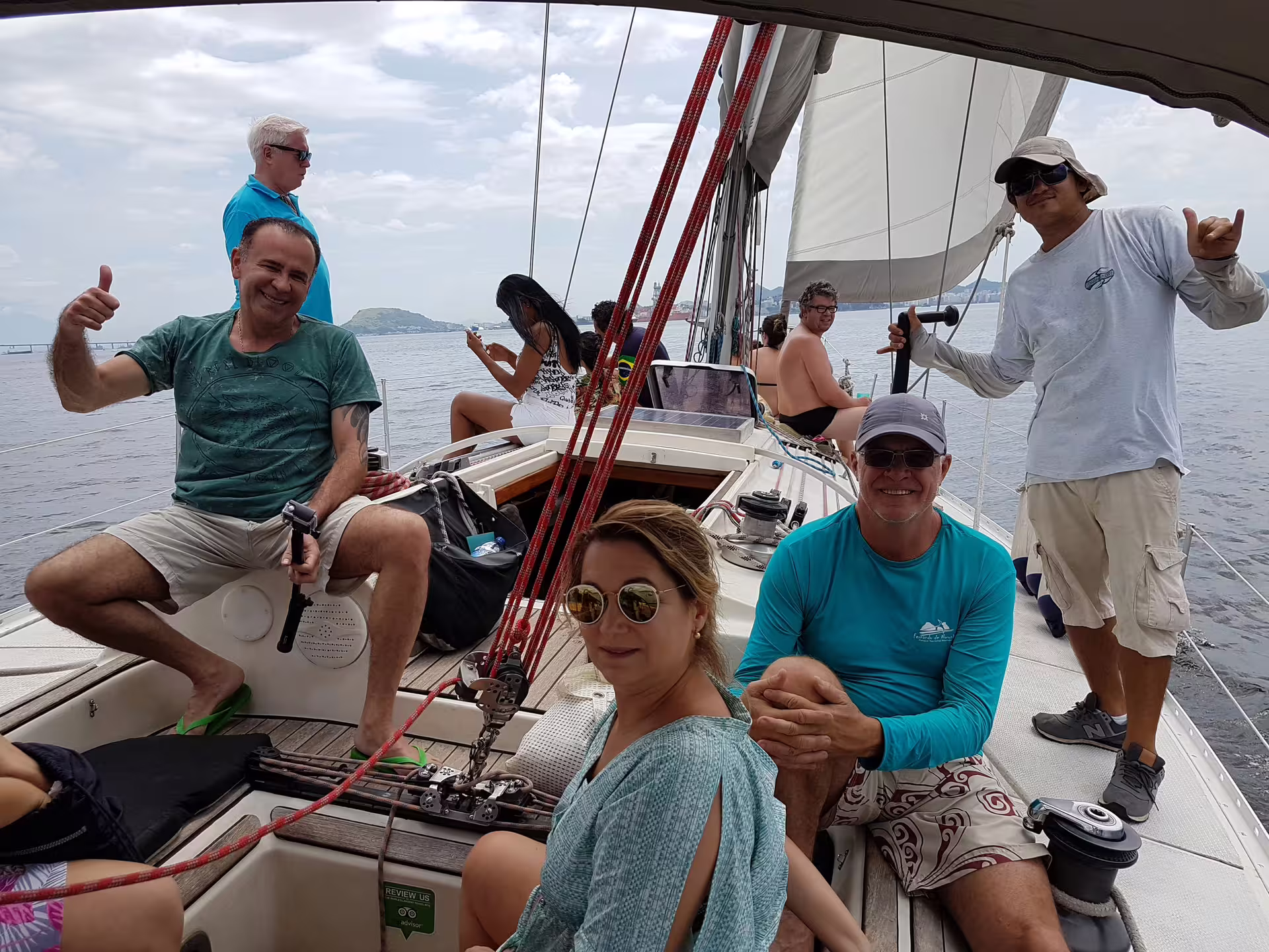 Happy group of people on a private sailing tour, capturing memories and enjoying the open sea.
