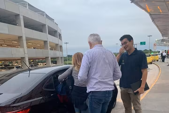 Travelers being greeted by a private driver at Rio de Janeiro airport, ready for their shuttle to Buzios.