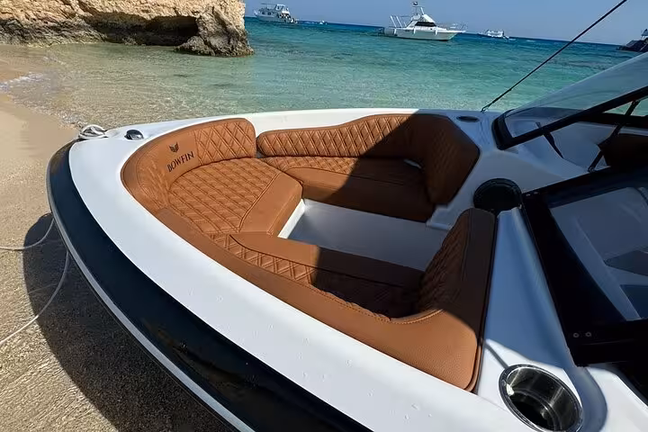 Friends relaxing on a private speedboat in Hurghada, Red Sea, heading out for dolphin watching and snorkeling