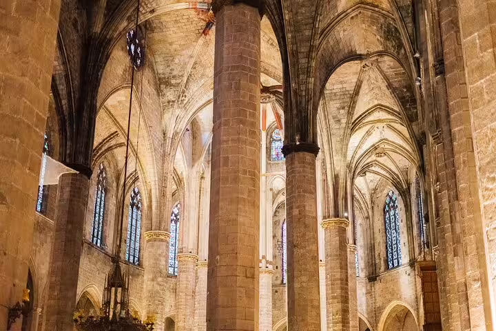 Interior of a historic cathedral with Gothic arches, a highlight of the private tapas and wine walking tour experience.