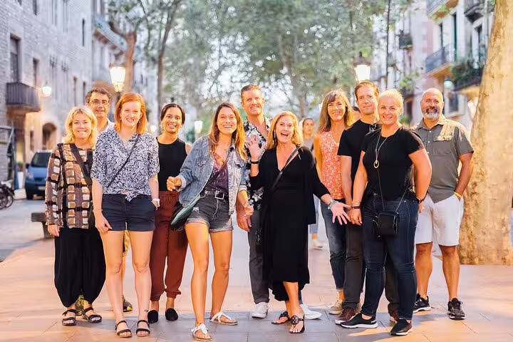 Group enjoying private tapas and wine walking tour through scenic streets, highlighting vibrant local experiences.