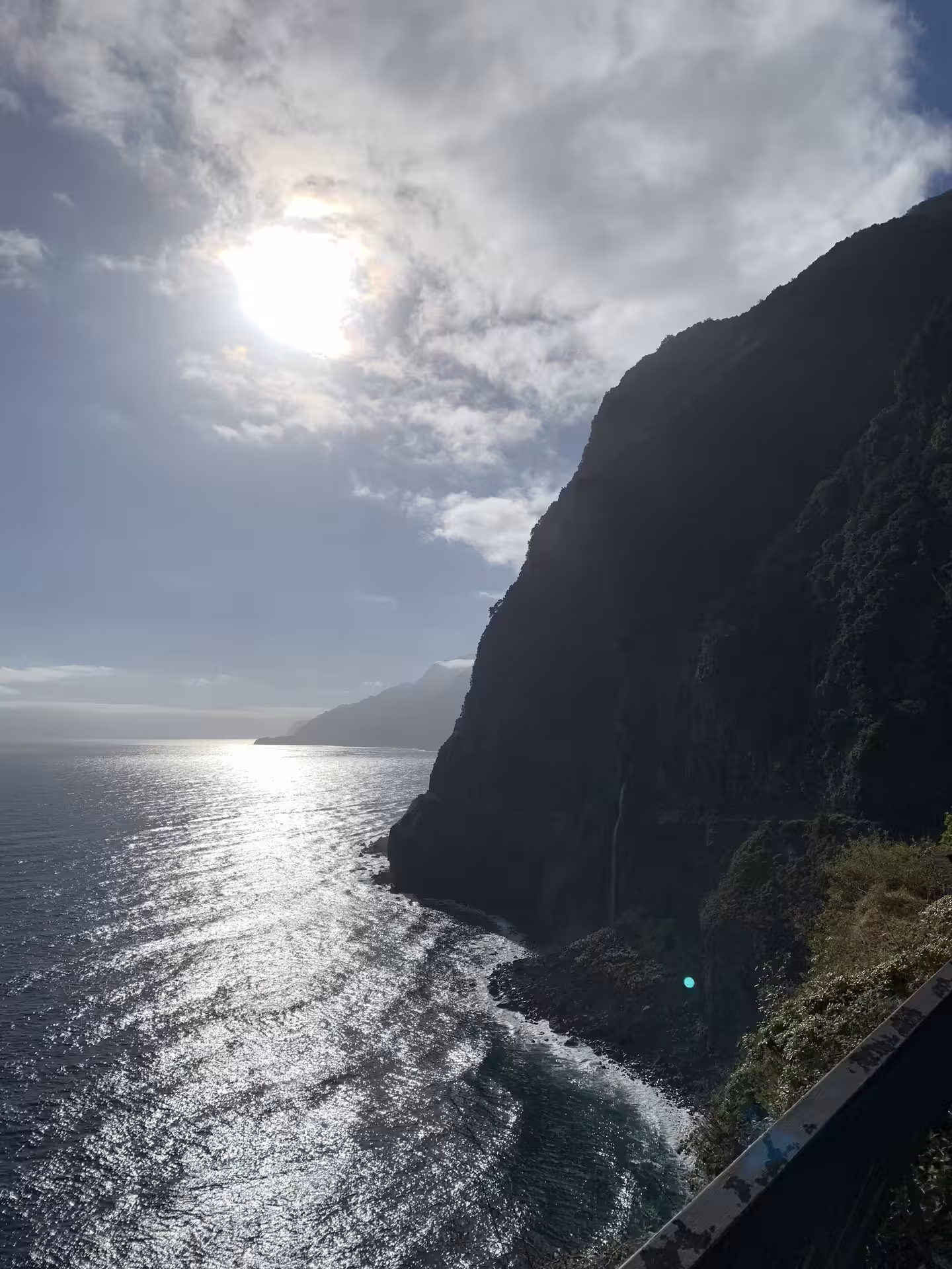 Scenic coastal view with sunlight reflecting on the ocean, ideal for a private tour with up to six participants.