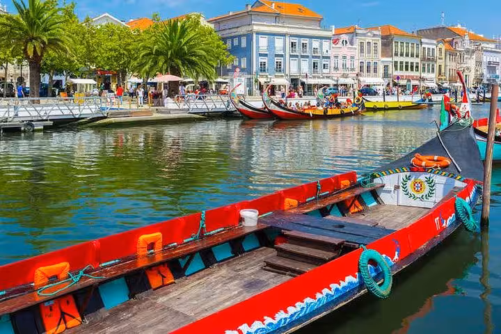 Discover colorful boats along the picturesque canals of Aveiro during a private 2-day tour from Porto.