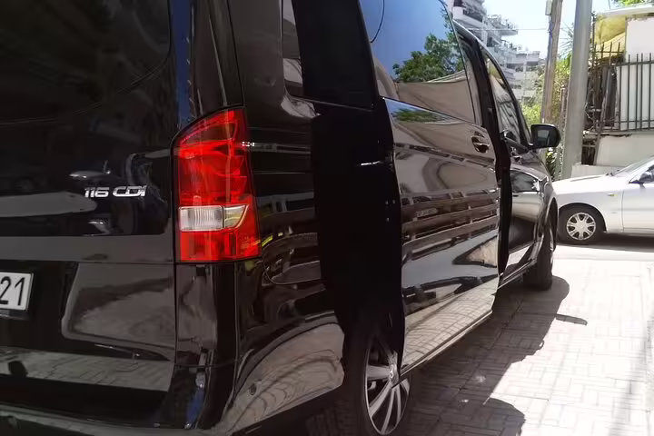 Black minivan with sliding door open for private transfer from Athens to Delphi, Greece hotel pickup