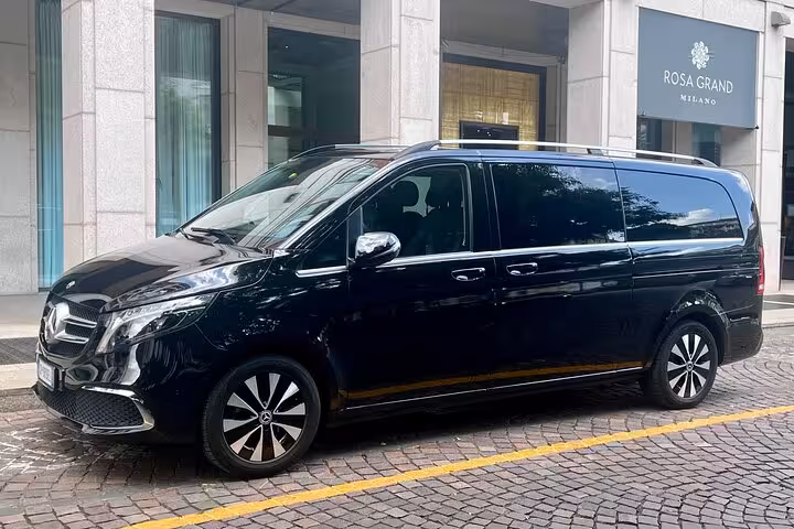 Elegant black Mercedes van ready for private transfer service from Bologna Airport to Florence's city center.