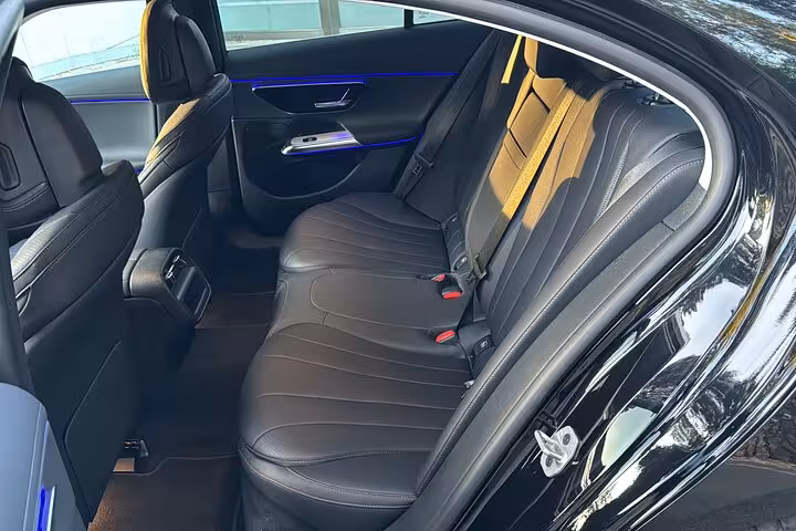 Luxurious interior of a private transfer vehicle from Civitavecchia Port to Rome, featuring plush leather seating.