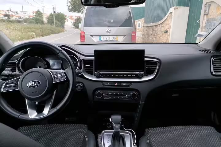 Interior view of a modern Kia car in Portugal, showcasing comfort and style for private transfers to Faro, Albufeira, and more.