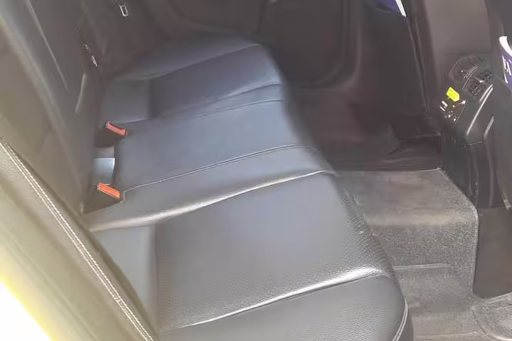 Spacious rear leather seats in private transfer car from Kyllini Port to Athens, air-conditioned comfort