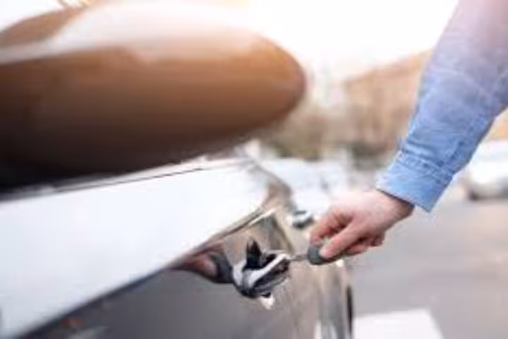 Traveler unlocking private transfer car for Marsa Alam to Hurghada ride with door key and chauffeur service