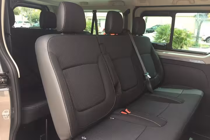 Spacious black leather van seats for private transfer Marseille to Lyon with comfortable rear cabin