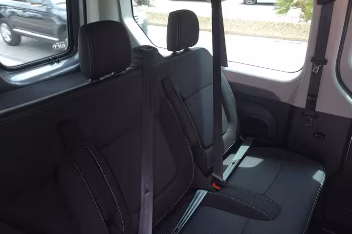 Clean black minivan bench seats for Marseille to Montpellier private transfer, safe seatbelts and legroom