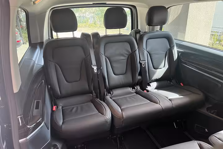 Spacious and comfortable leather seats in a private transfer vehicle from Milan to St. Moritz, ensuring a luxurious journey.