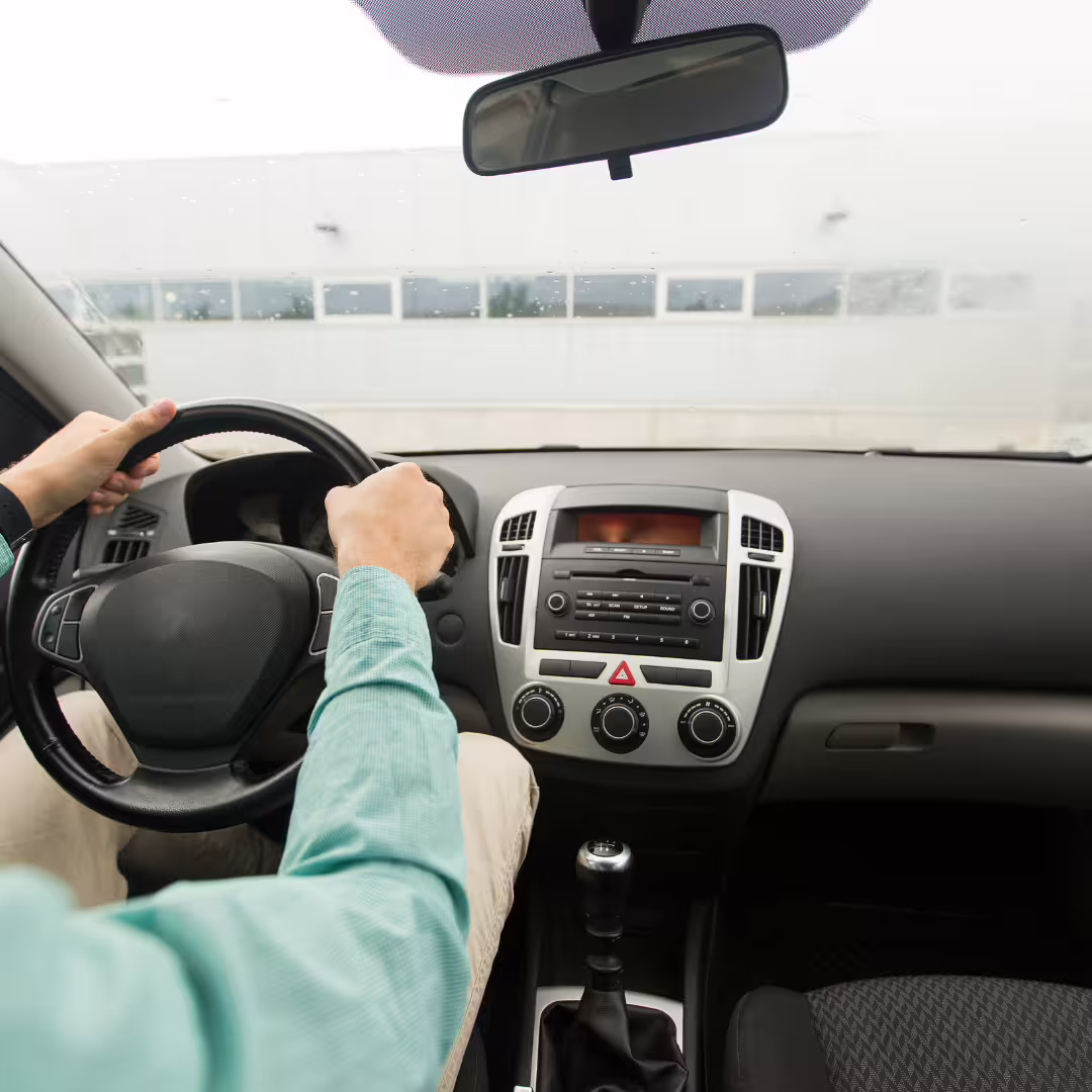 Professional driver at the wheel of a modern car providing private transfer service between Naples and Avellino