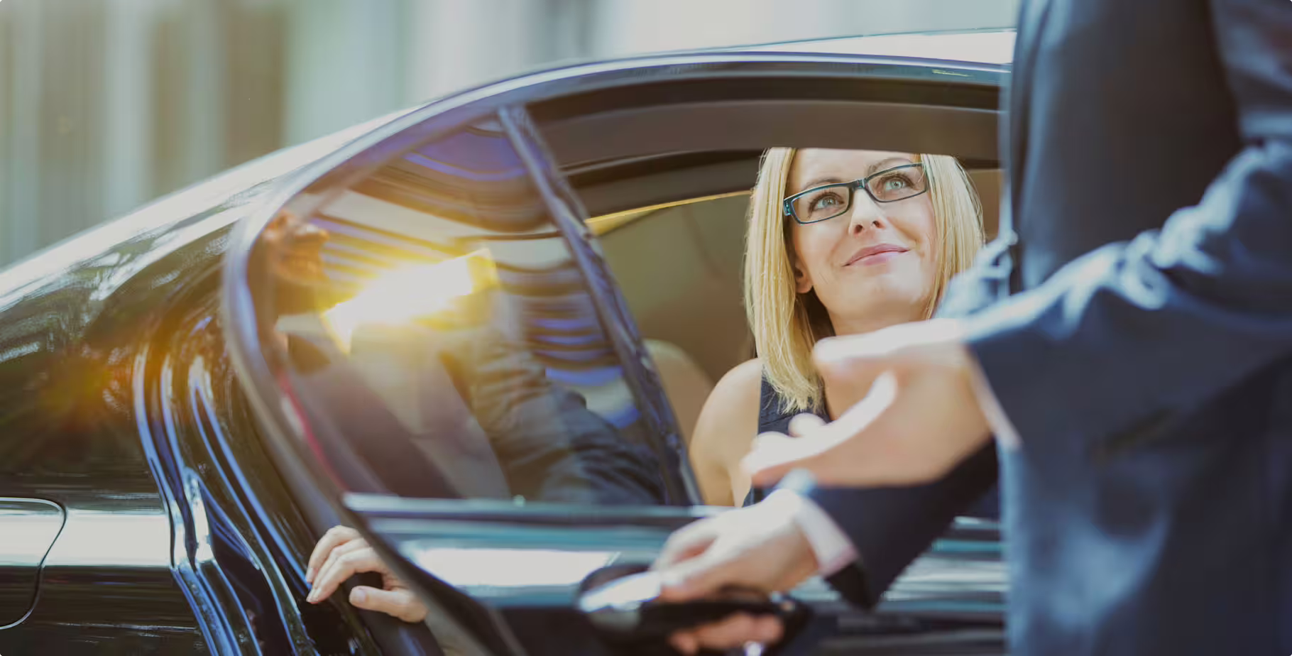 Private transfer Naples to Rome with professional driver opening luxury car door for passenger