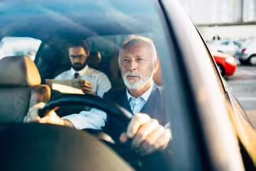 Professional chauffeur driving executive car for private transfer between Naples and Salerno or Vietri sul Mare