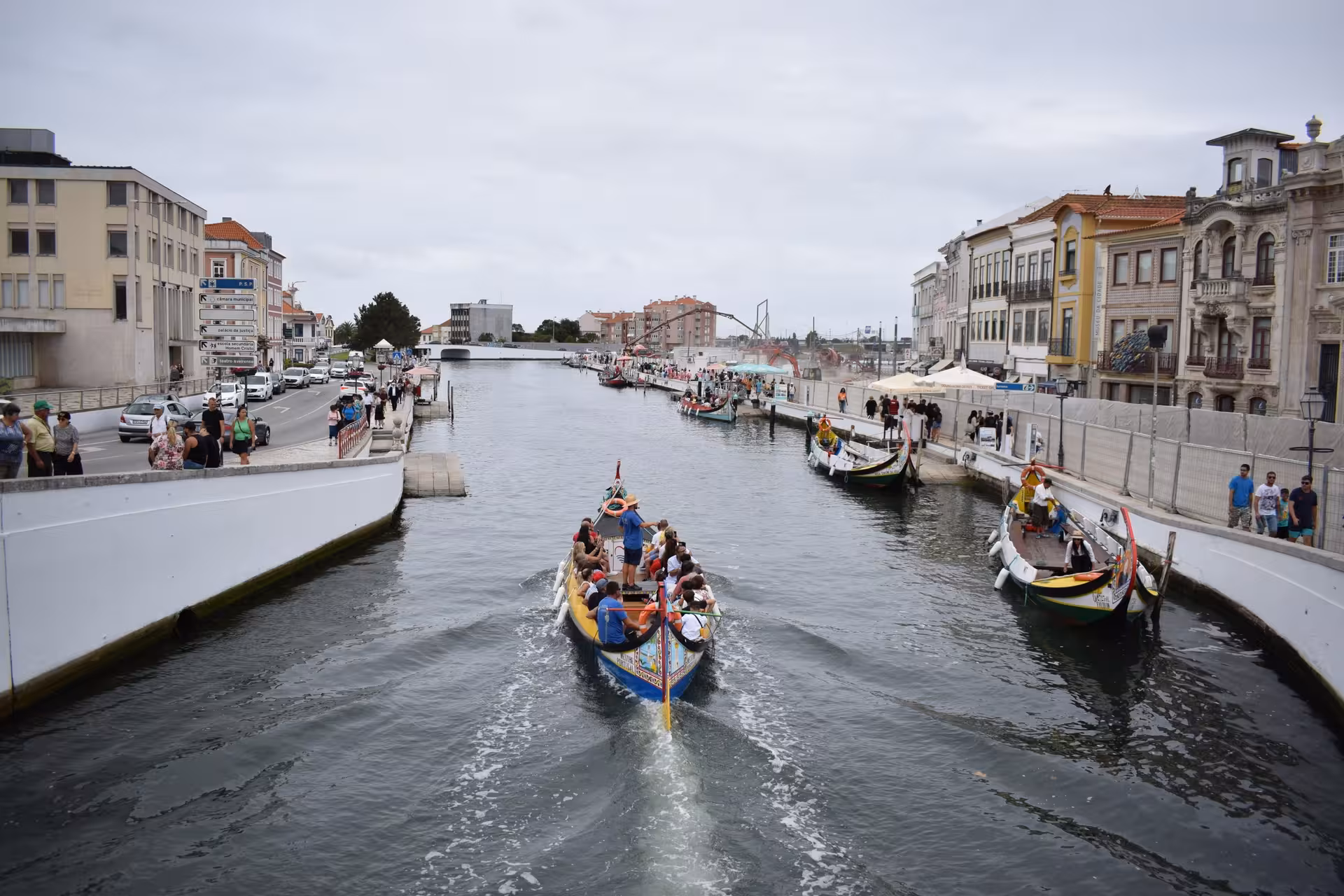 Private transfer from Porto to Aveiro, with traditional moliceiro boats cruising the canal waterfront