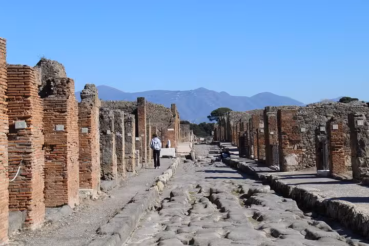 Explore the ancient ruins of Pompeii with a private transfer from Rome, capturing the historic streets and architecture.